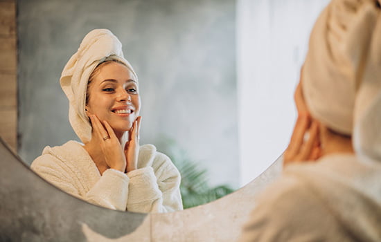 rev-woman-home-applying-cream-mask rev-woman-home-applying-cream-mask