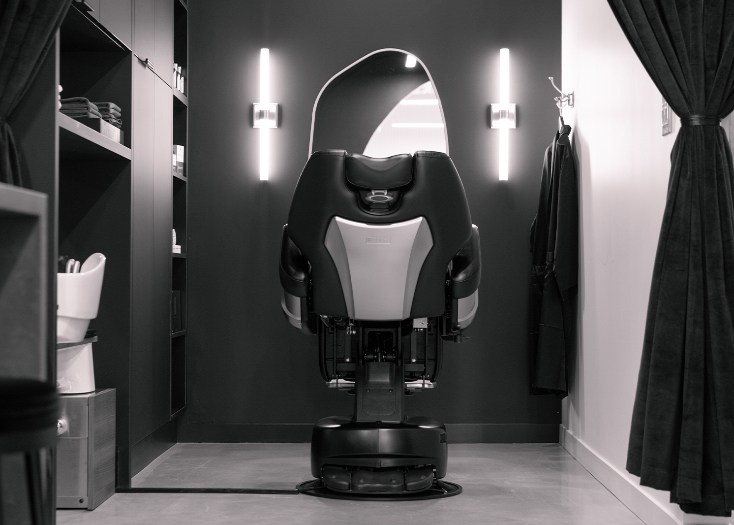 Aesthetic black and white image of the back of a state-of-the-art treatment chair in Oo Spa's treatment room, showcasing a sleek and modern design that enhances the spa experience.